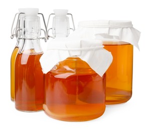 Tasty kombucha in glass jars and bottles isolated on white