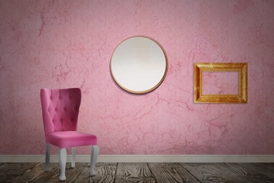 Image of Chair near wall with mirror, wooden frame and patterned wallpaper. Stylish room interior