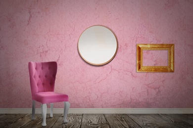 Chair near wall with mirror, wooden frame and patterned wallpaper. Stylish room interior