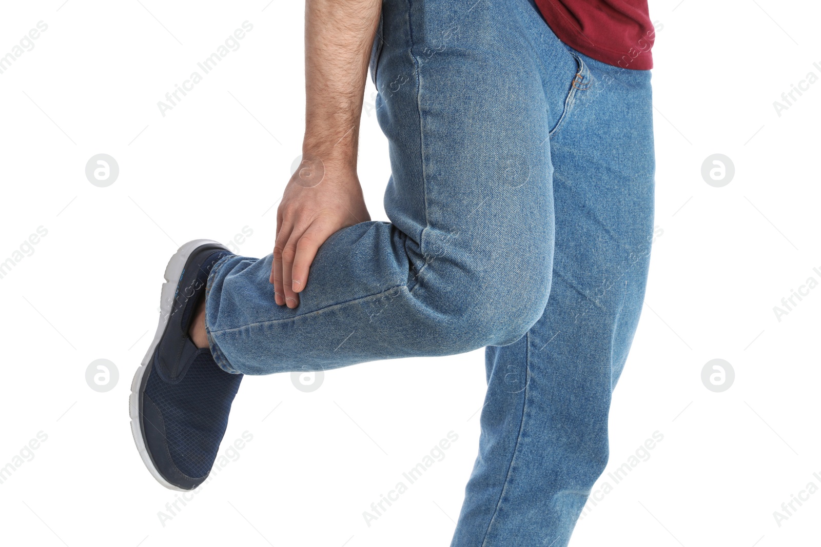 Photo of Young man suffering from leg pain on white background, closeup