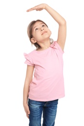 Little girl measuring her height on white background