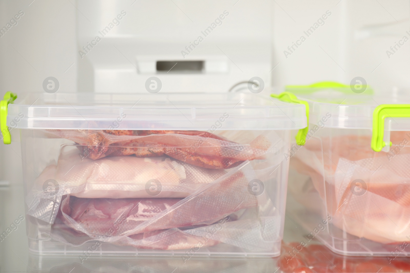 Photo of Vacuum bags with different products in fridge, closeup. Food storage