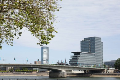 Picturesque view of modern city architecture and bridge over river