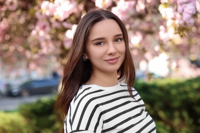 Photo of Beautiful woman near blossoming tree on spring day