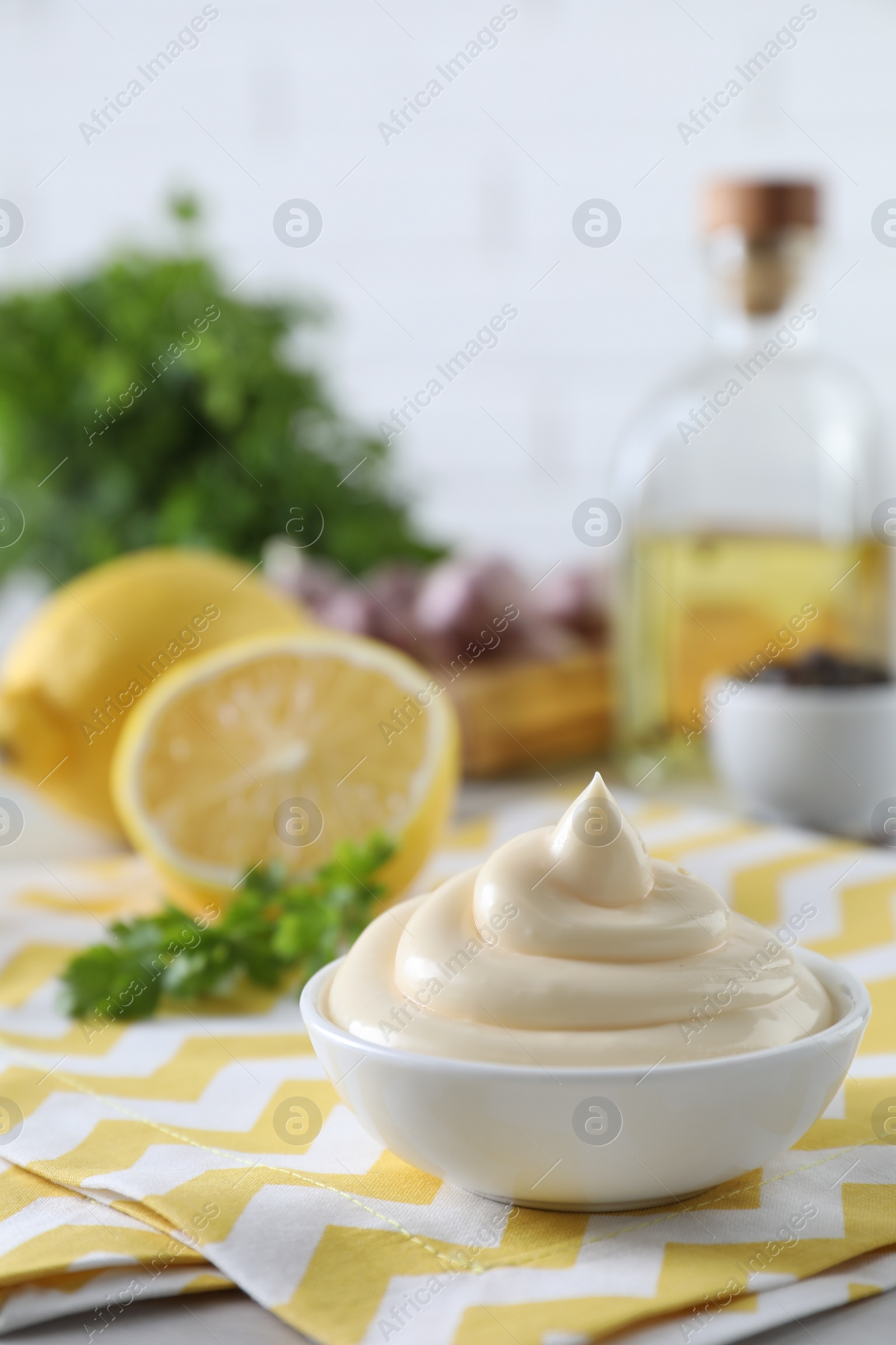 Photo of Tasty mayonnaise sauce in bowl on table. Space for text