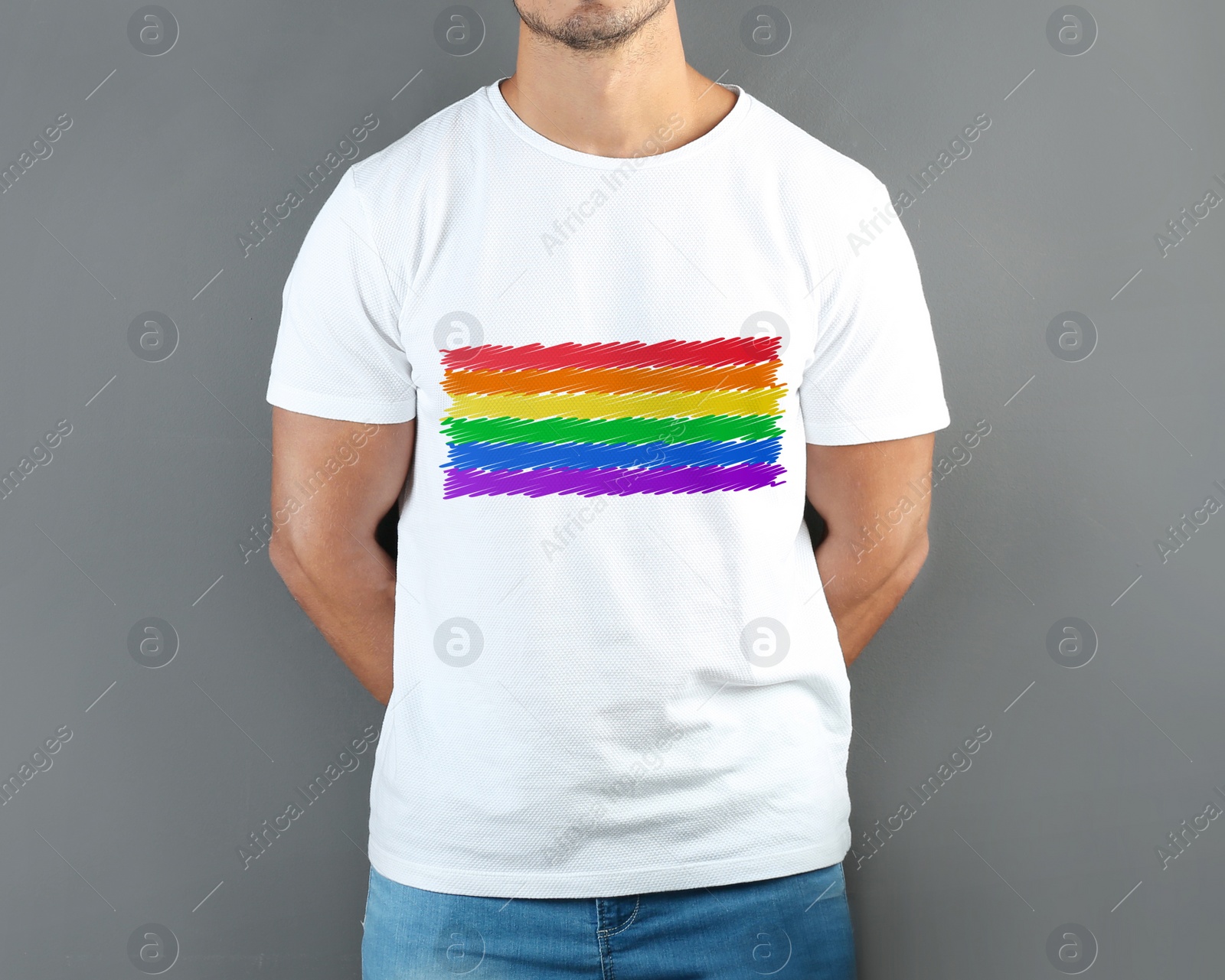 Image of Young man wearing white t-shirt with image of LGBT pride flag on grey background