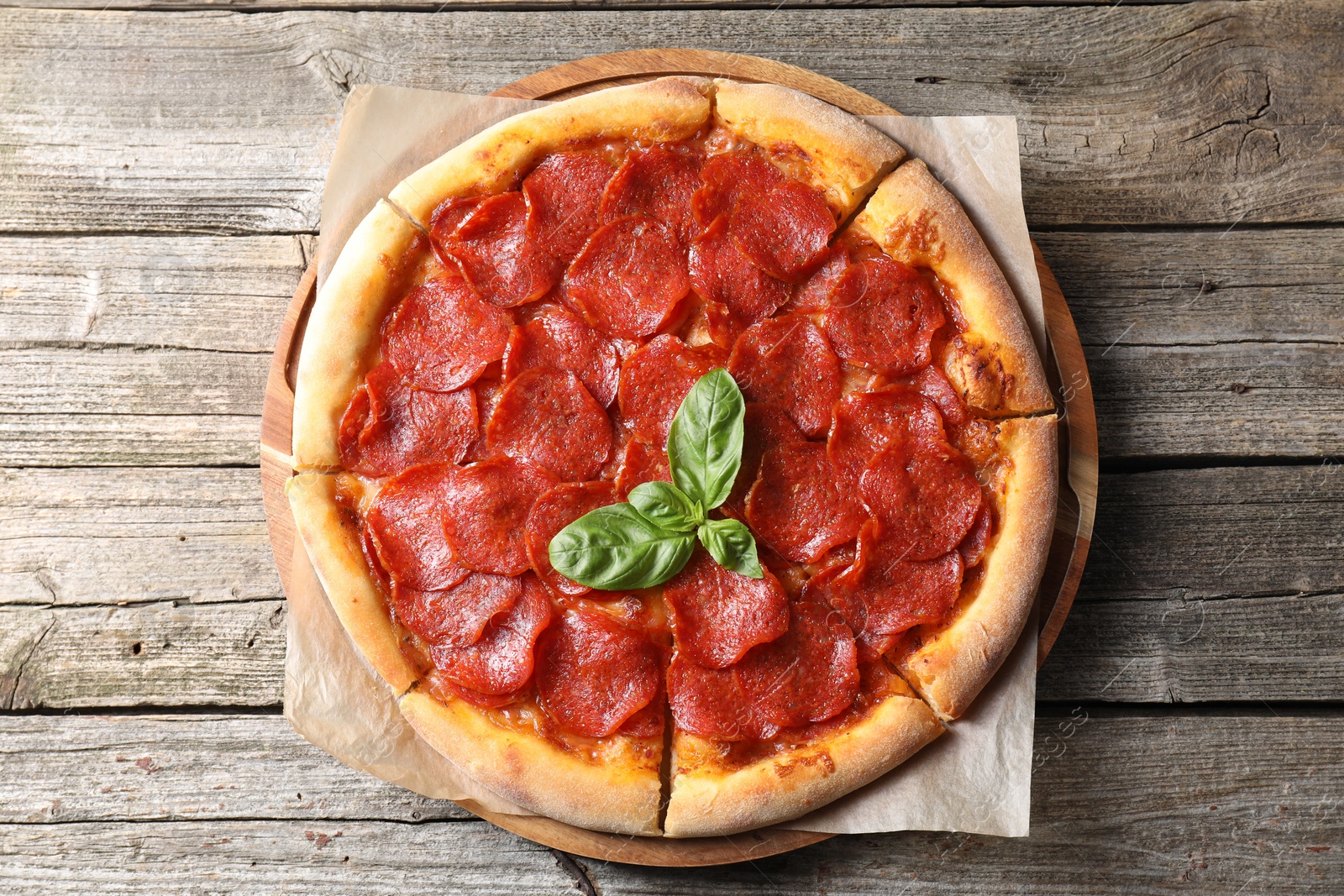 Photo of Tasty pepperoni pizza on wooden table, top view