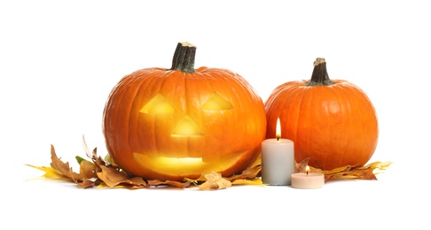 Photo of Pumpkins, candles and autumn leaves on white background. Halloween decor