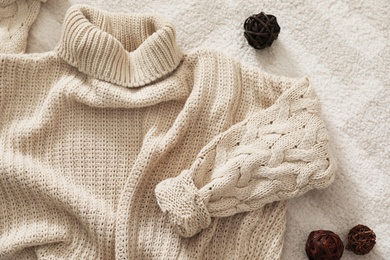 Photo of Flat lay composition with cozy knitted sweater on carpet