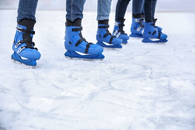 Photo of Friends at ice skating rink outdoors, closeup. Space for text