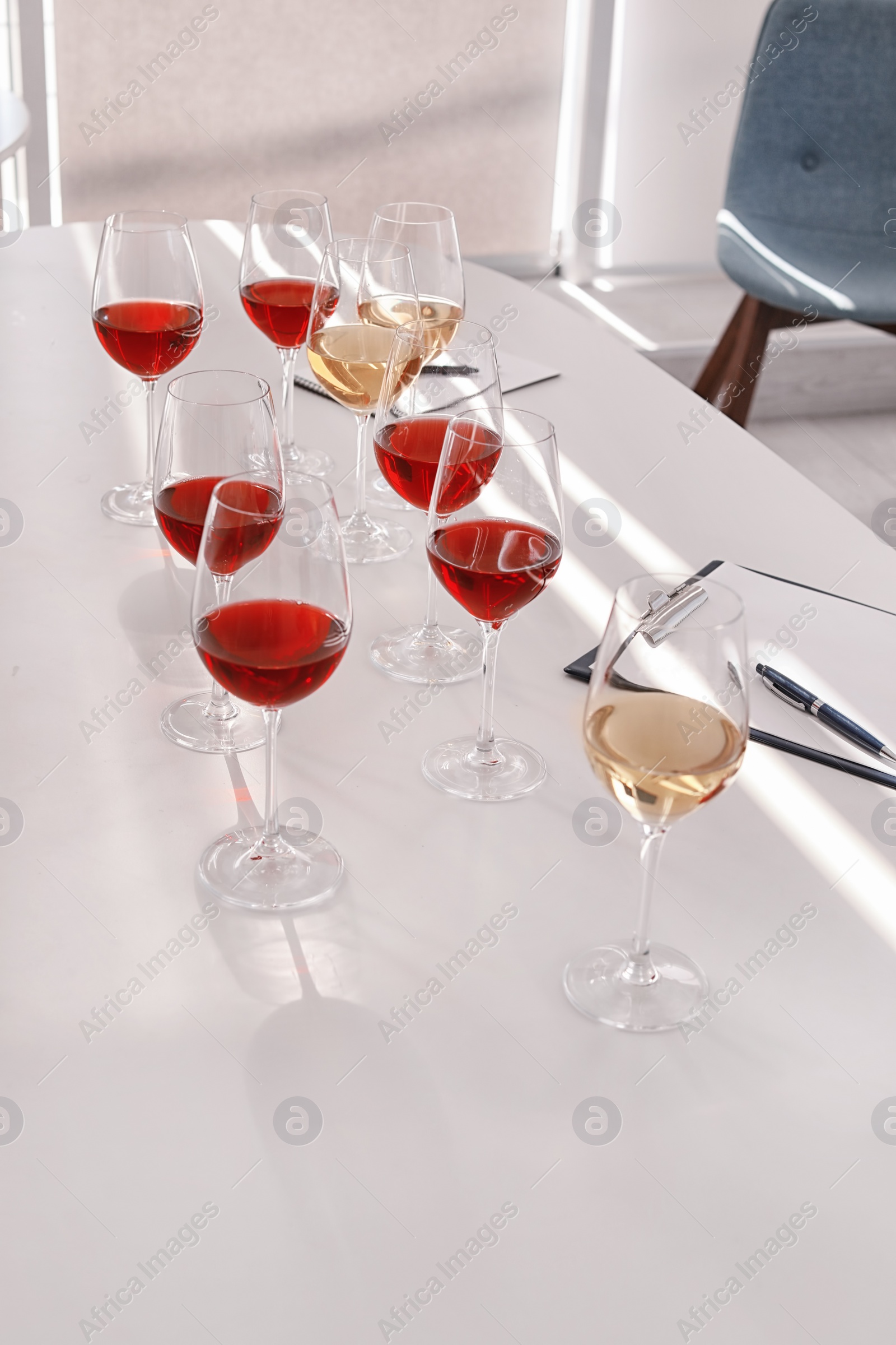 Photo of Glasses with delicious wine on table indoors