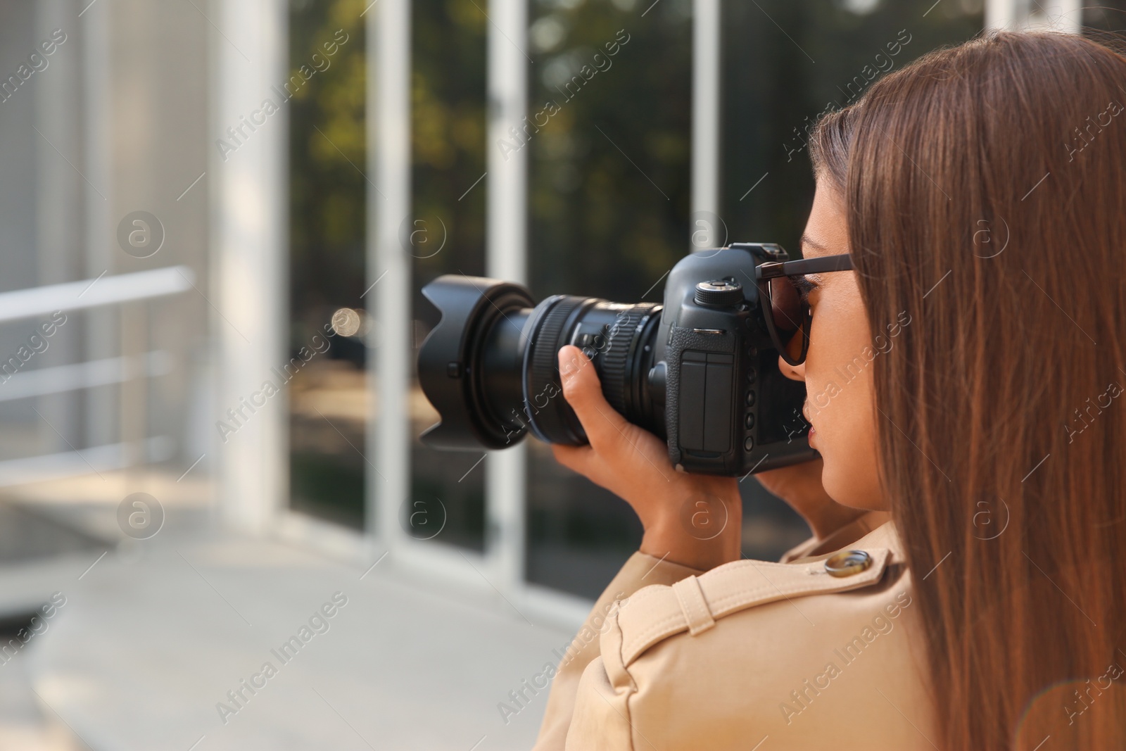 Photo of Private detective with camera spying on city street