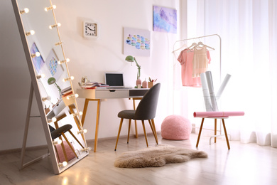 Photo of Large mirror with light bulbs in stylish room interior