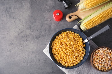 Photo of Flat lay composition with corn kernels on grey background. Space for text