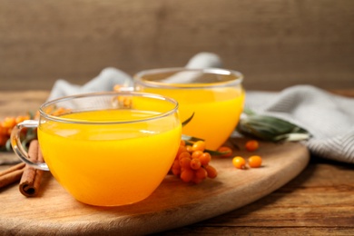 Fresh sea buckthorn tea on wooden table