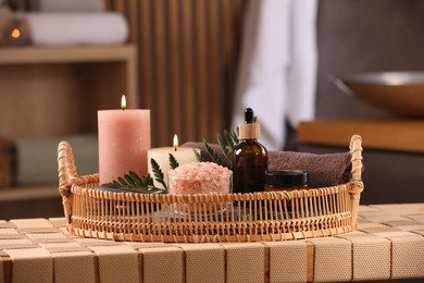 Beautiful composition with different spa products on wicker bench indoors