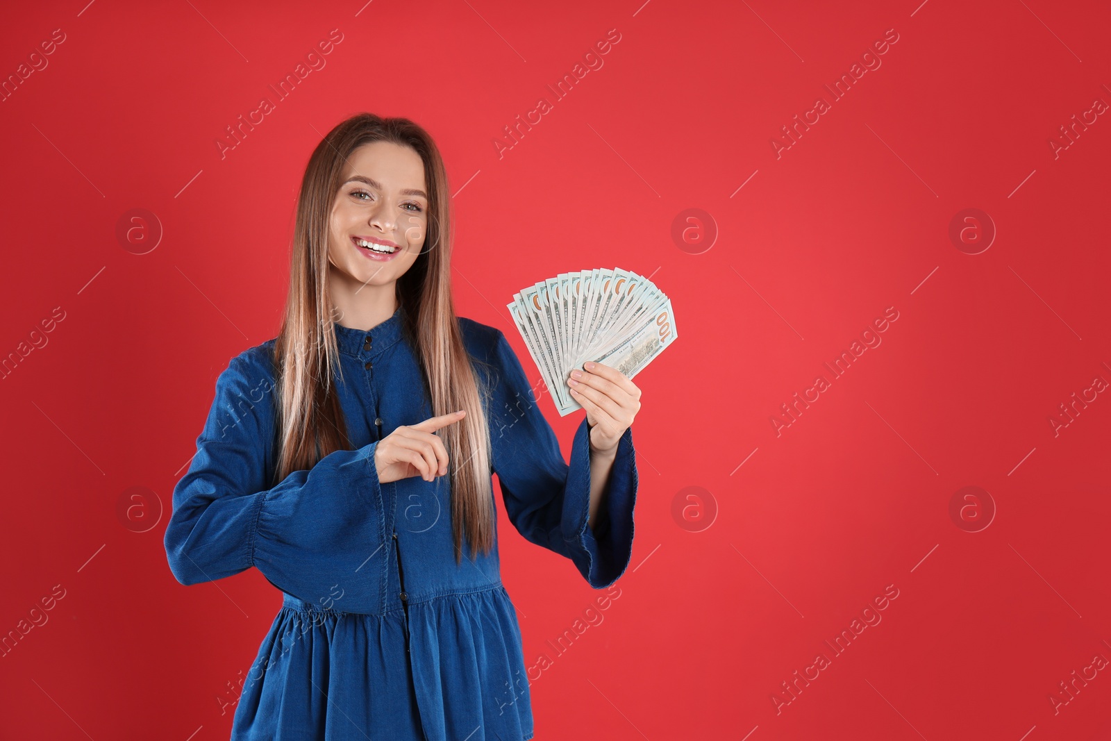Photo of Young woman with money on crimson background. Space for text