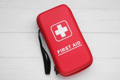 Photo of Medicine bag on white wooden table, top view. First aid kit