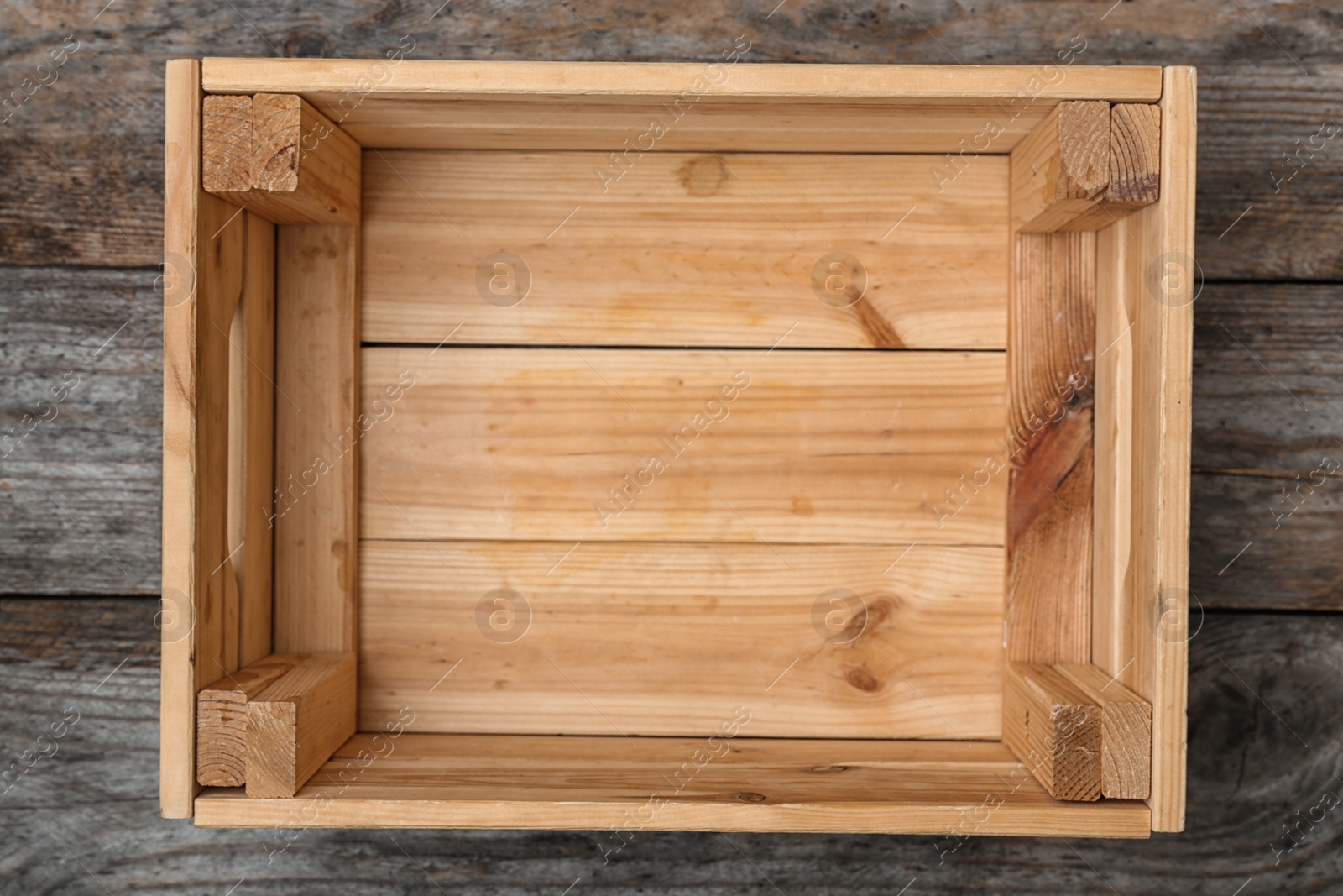 Photo of Empty crate on wooden background, top view