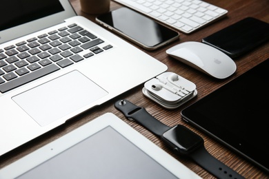 MYKOLAIV, UKRAINE - JULY 20, 2020: Composition with iPhone 11 and different Apple gadgets on wooden table