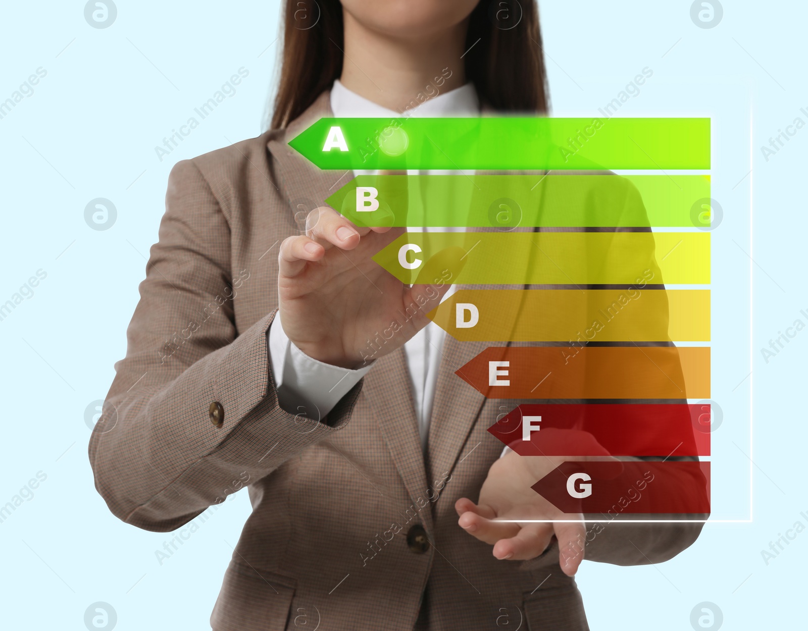 Image of Energy efficiency. Woman touching colorful rating on digital screen against light background, closeup