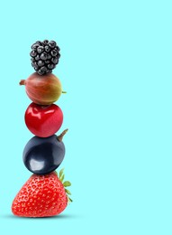 Image of Stack of different fresh tasty berries and cherry on cyan background, space for text