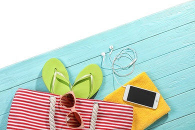 Photo of Flat lay composition with beach accessories on wooden background. Space for text