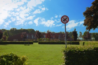 No dogs allowed sign in park on sunny day