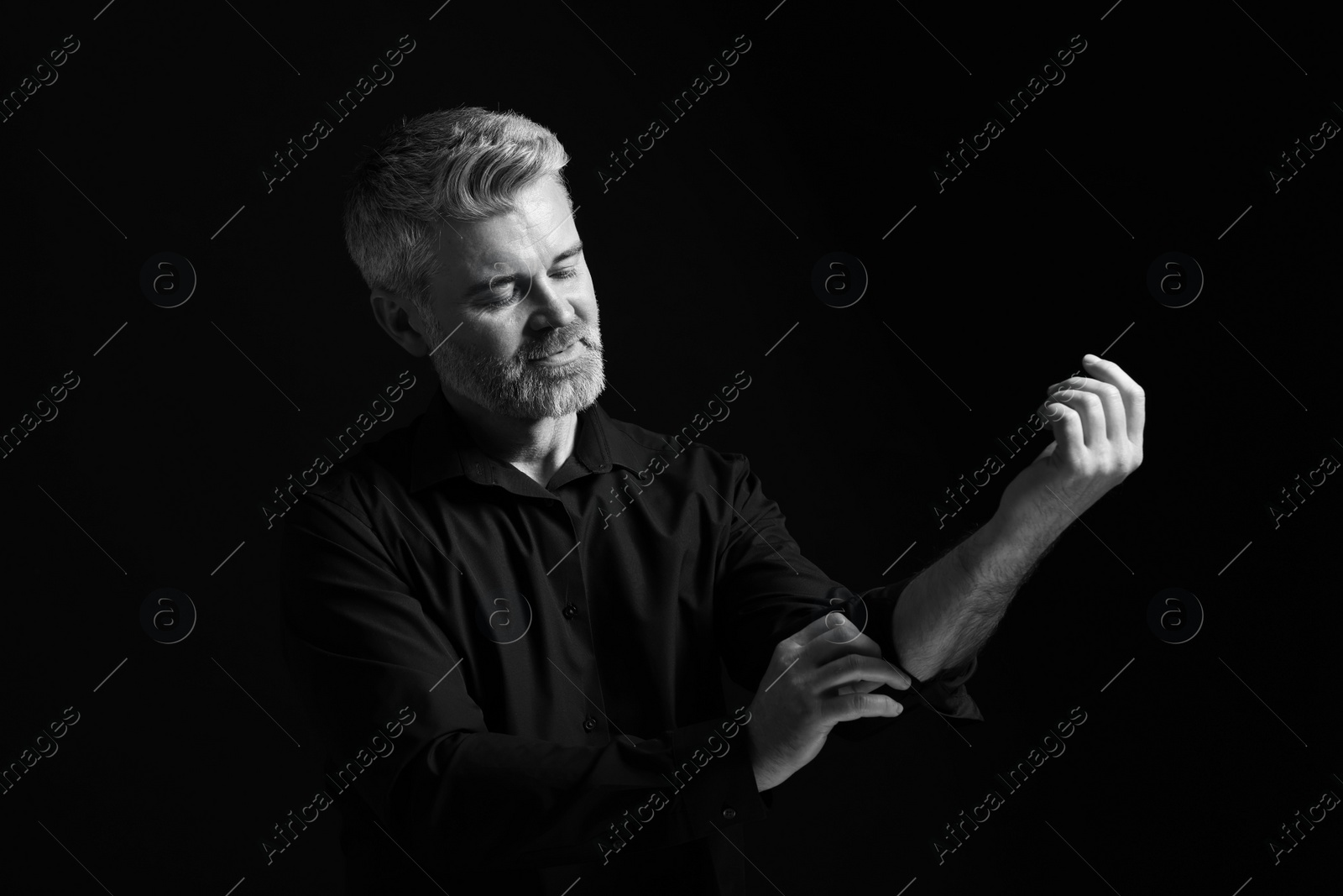 Photo of Portrait of handsome man on dark background. Black and white effect