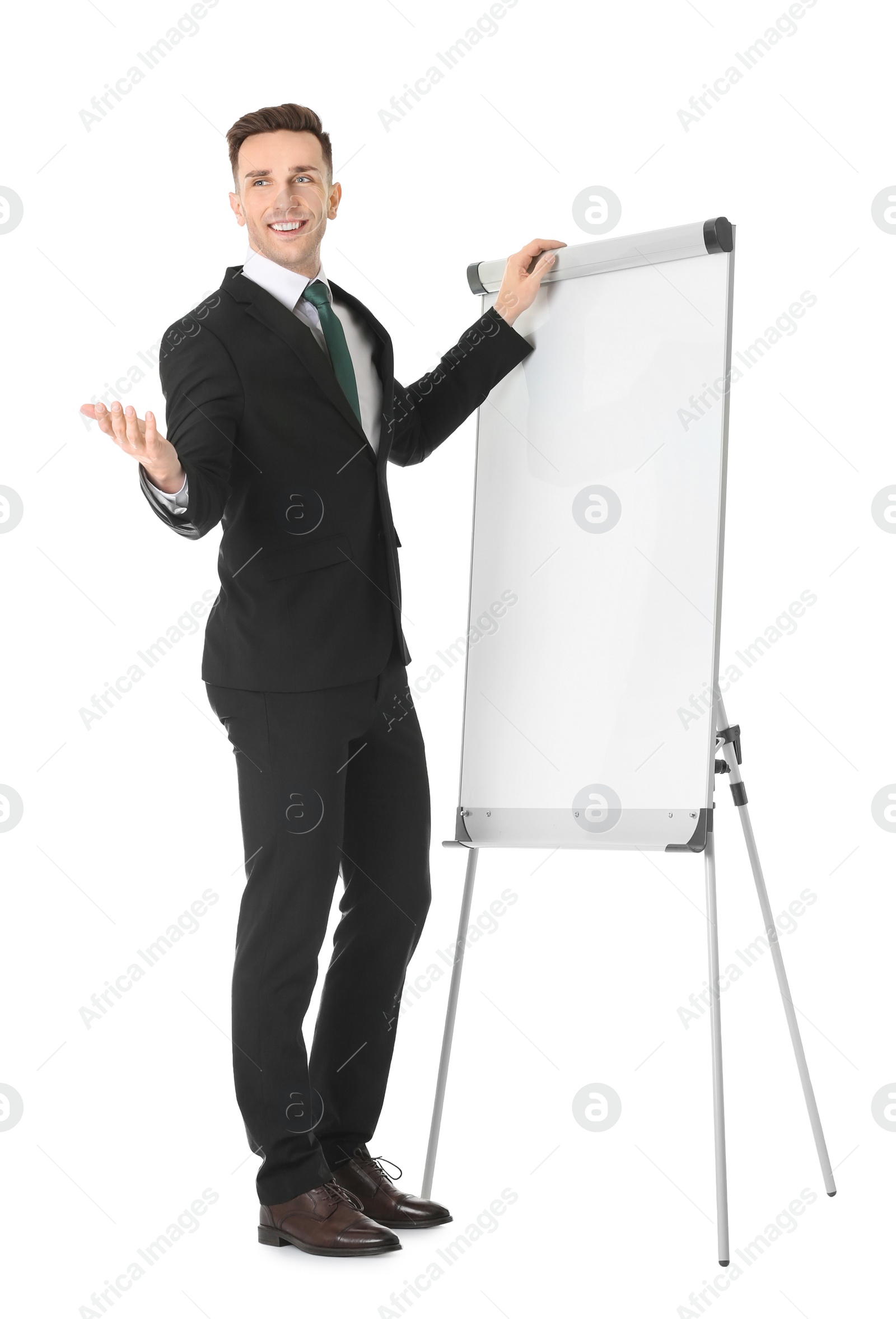 Photo of Young business trainer near flip chart on white background