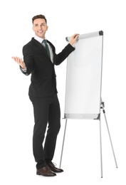 Photo of Young business trainer near flip chart on white background