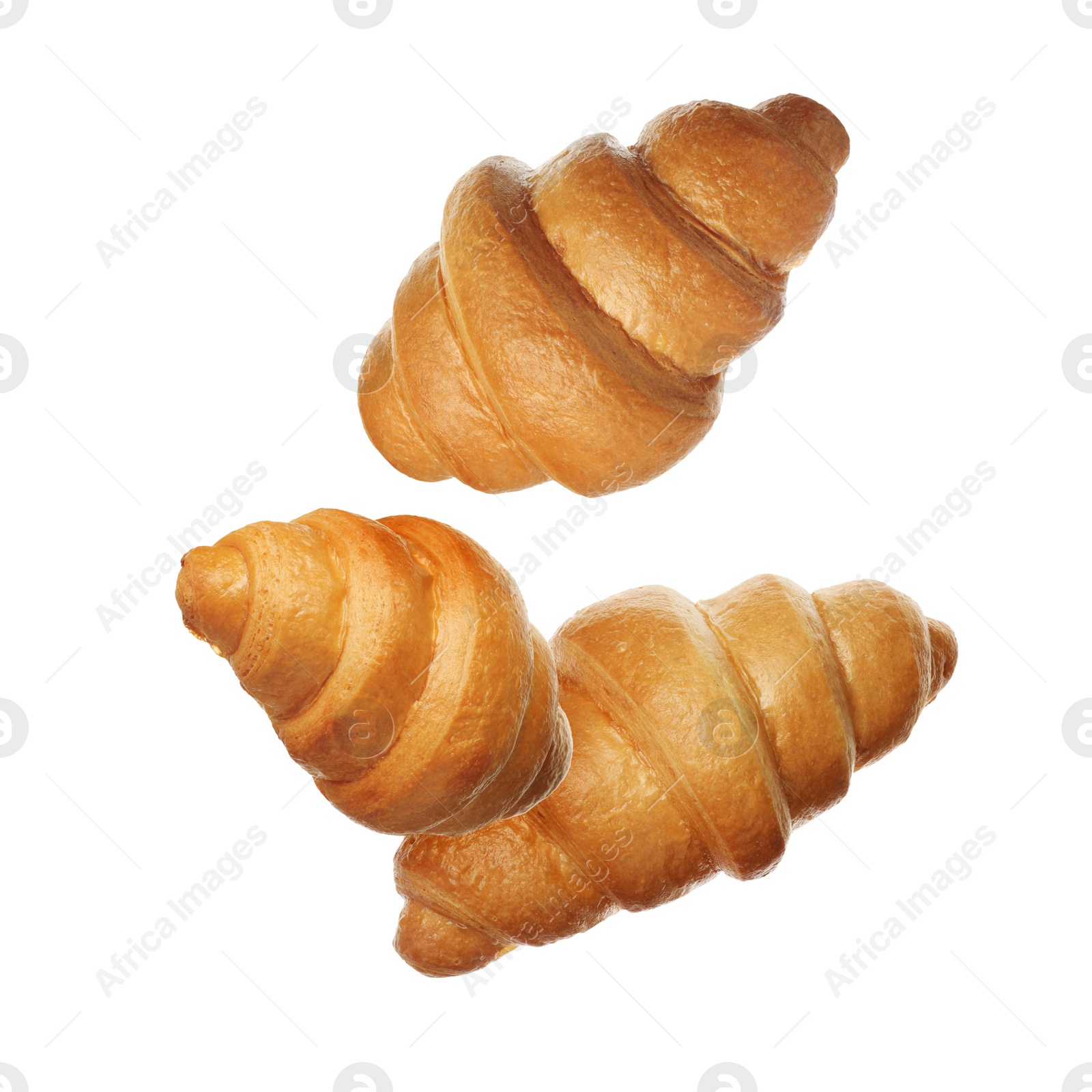 Image of Crusty golden croissants falling on white background