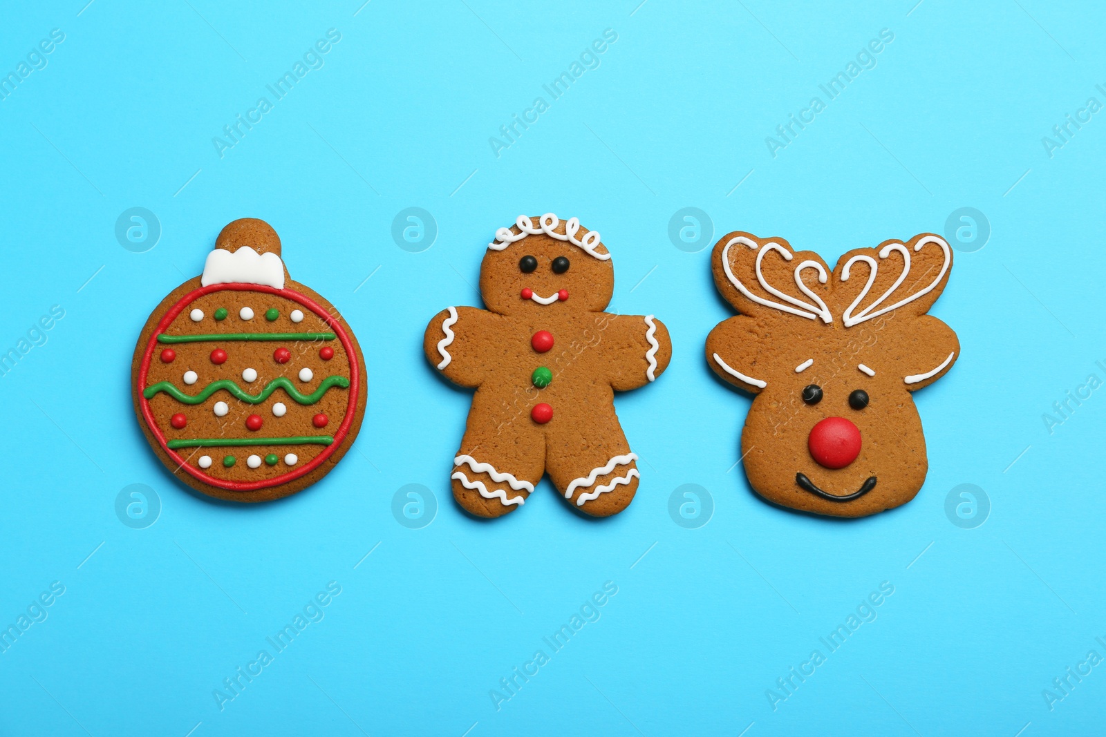 Photo of Different tasty Christmas cookies on light blue background, flat lay