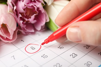 Photo of Person marking date 8th of March in calendar, closeup. International Women's Day