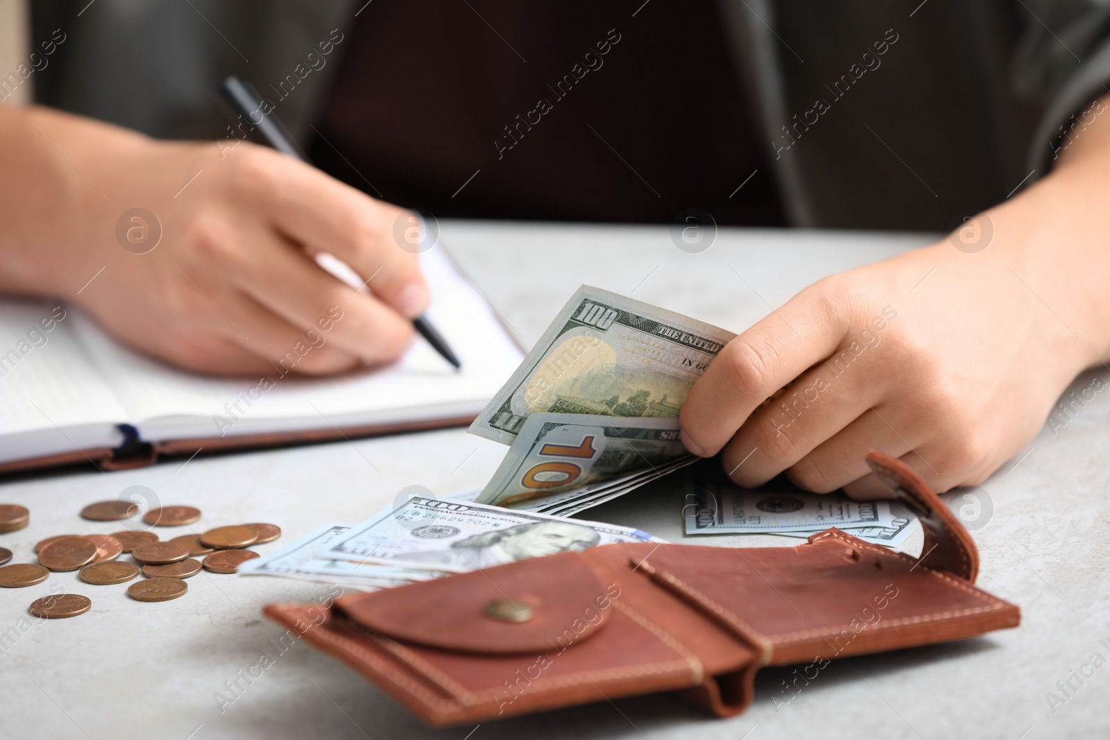 Photo of Man counting American money at table, closeup