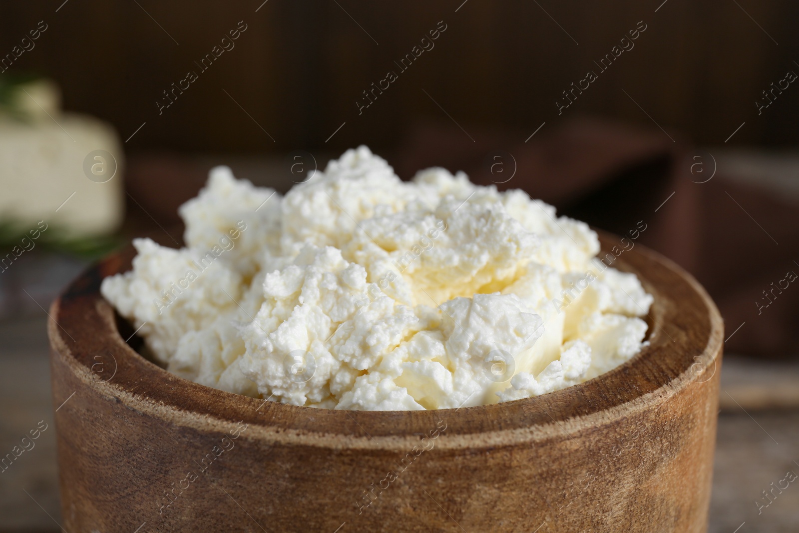 Photo of Delicious tofu cream cheese in wooden bowl, closeup