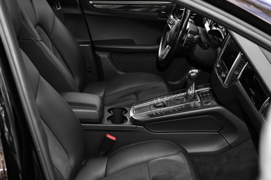 Photo of Inside of modern black car with leather seats