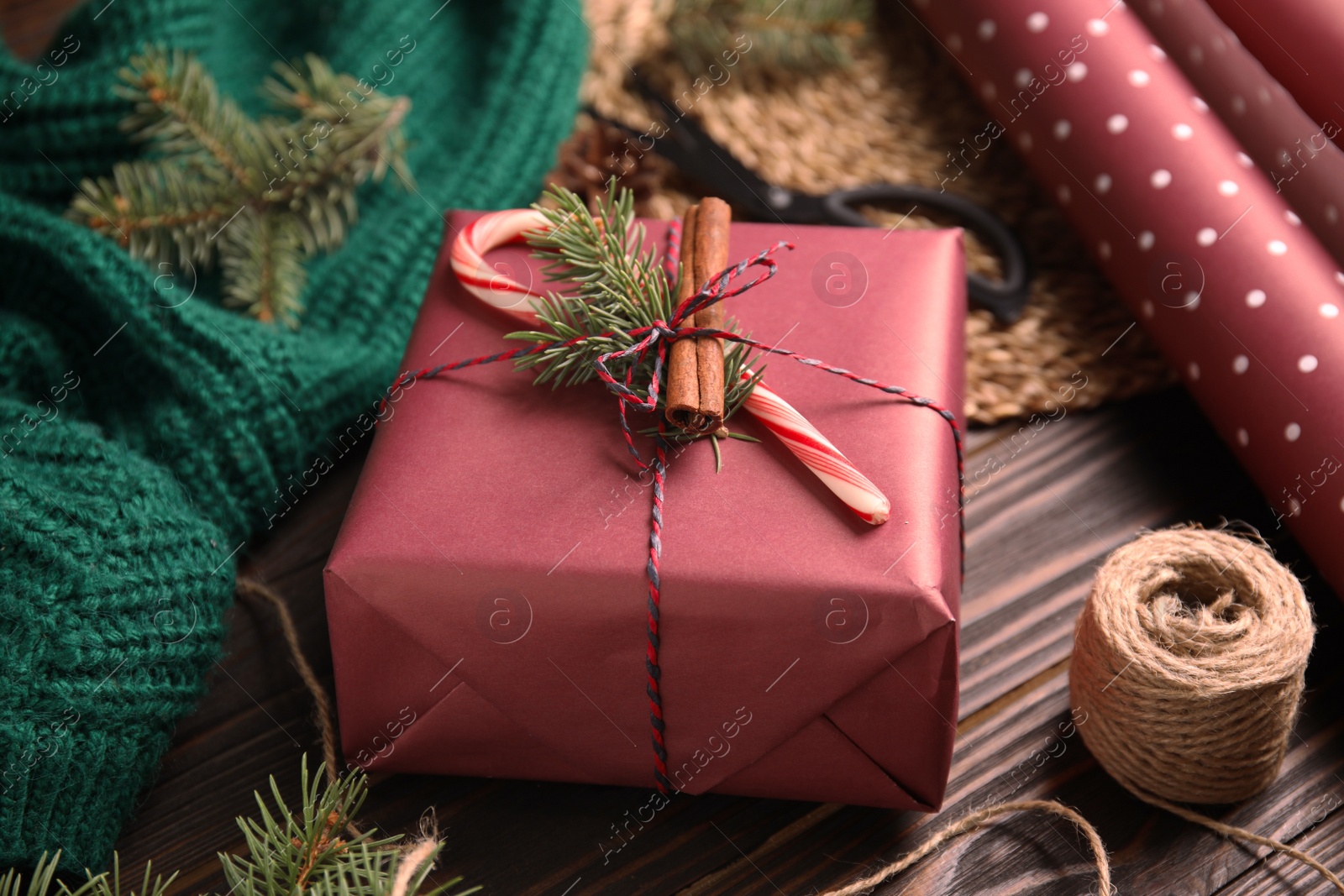 Photo of Composition with beautifully wrapped gift box on wooden table