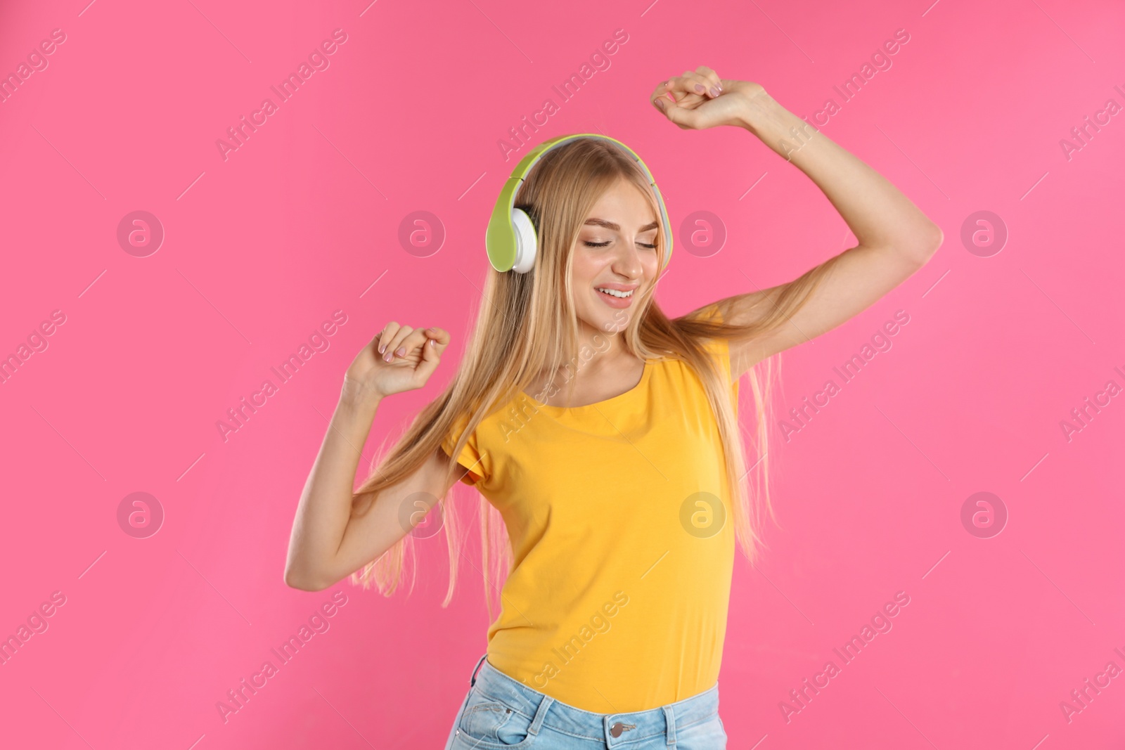 Photo of Beautiful young woman listening to music with headphones on color background