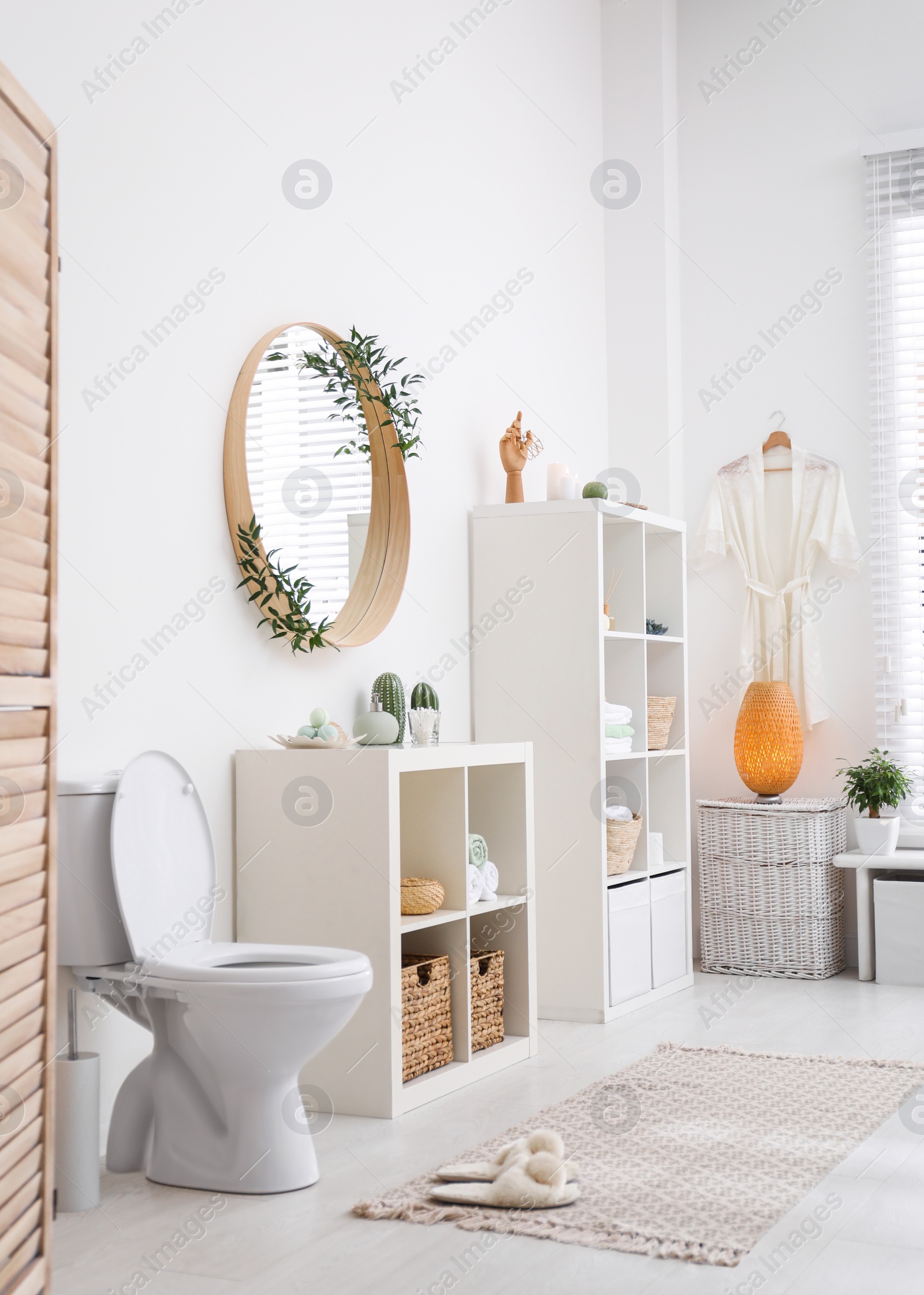 Photo of Interior of modern bathroom with round mirror