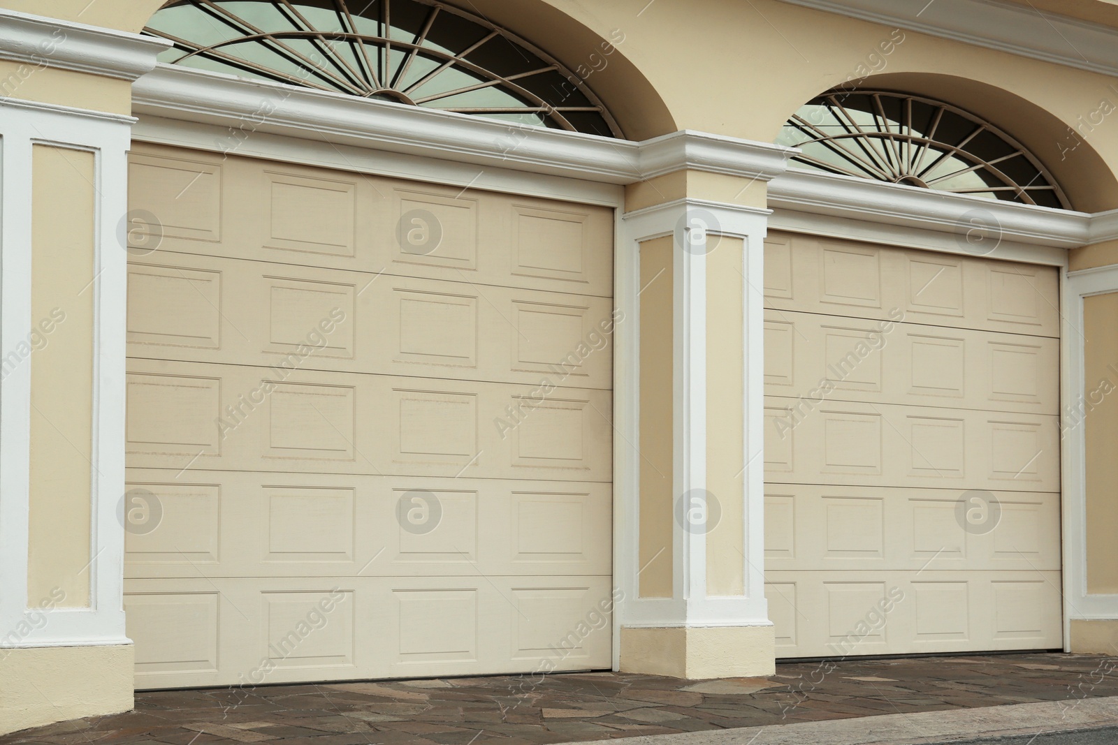 Photo of Building with beige sectional garage doors outdoors