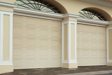 Building with beige sectional garage doors outdoors