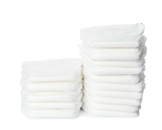 Stacks of baby diapers isolated on white
