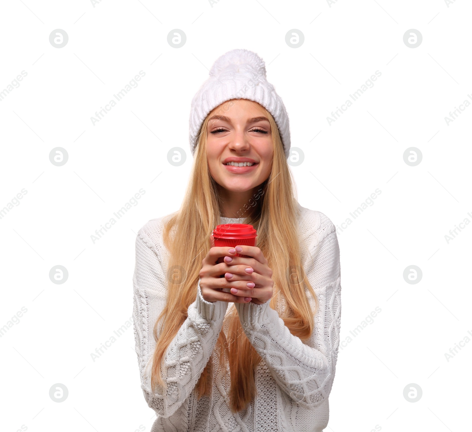 Photo of Portrait of young woman in stylish hat and sweater with coffee paper cup on white background. Winter atmosphere