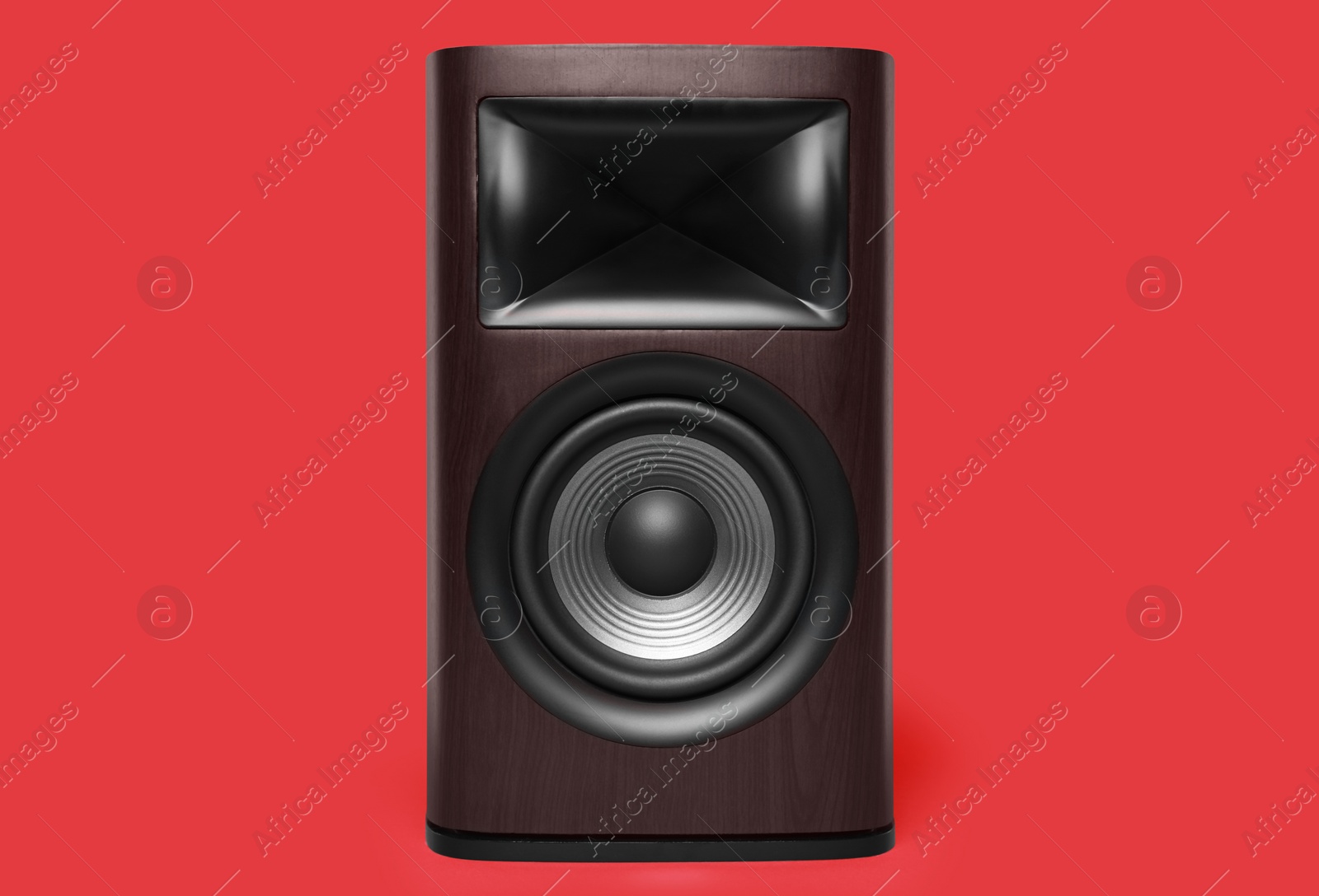 Photo of One wooden sound speaker on red background