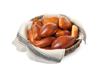 Wicker basket with delicious baked pirozhki on white background