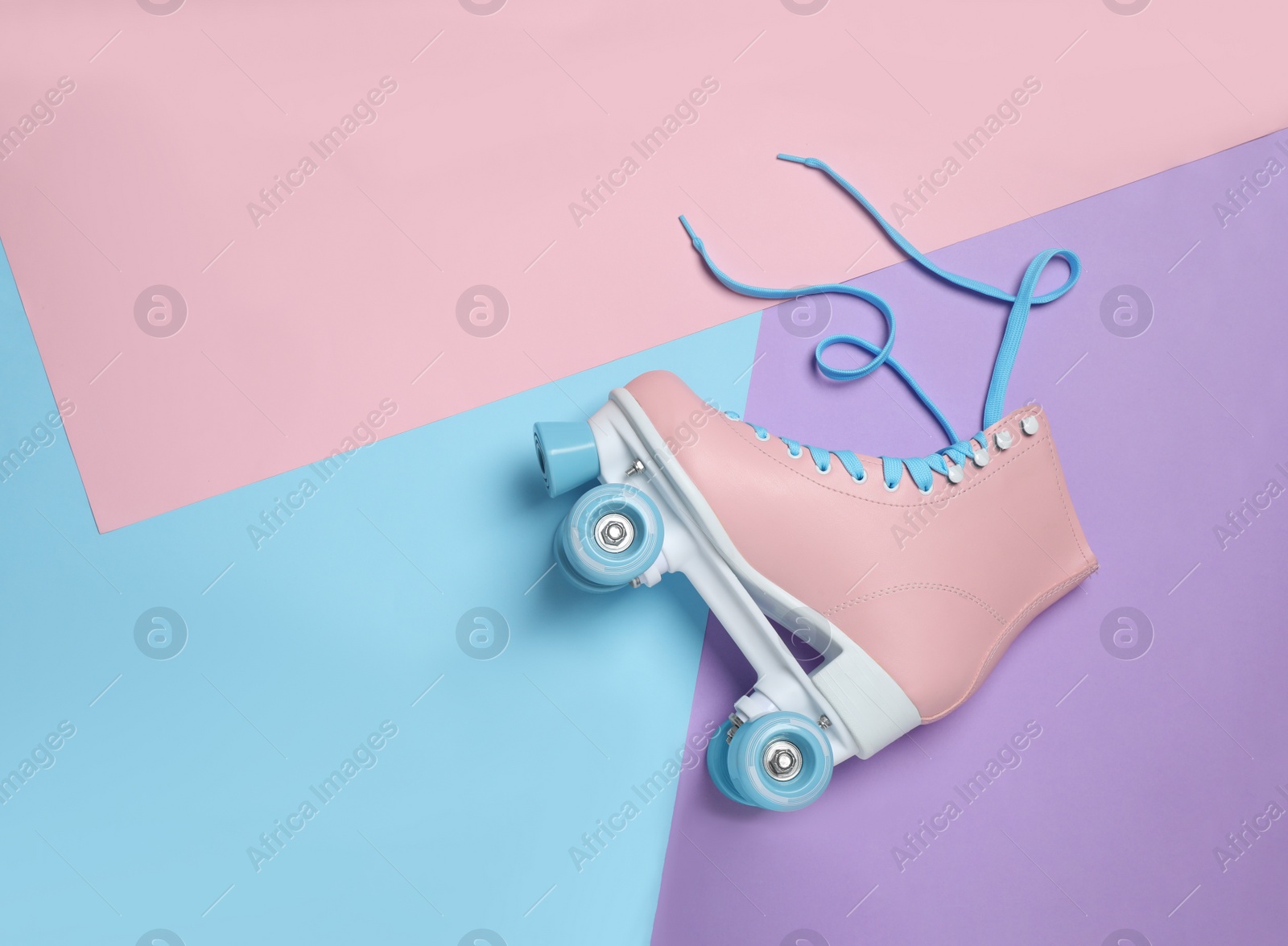 Photo of Stylish quad roller skate on color background, top view