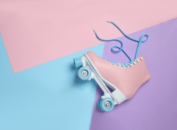 Photo of Stylish quad roller skate on color background, top view