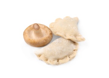Raw dumplings (varenyky) and fresh mushroom isolated on white