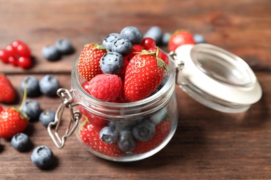 Photo of Mix of ripe berries on wooden table, closeup